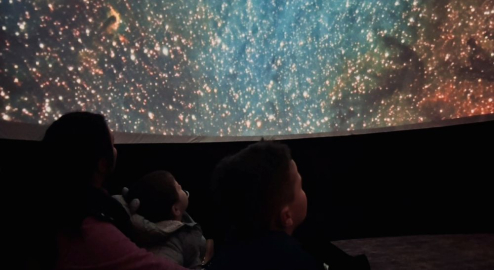 Family looking at the stars within the Wonderdome