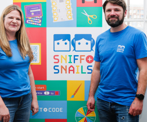 sniff and snails staff in front of banner with event resources