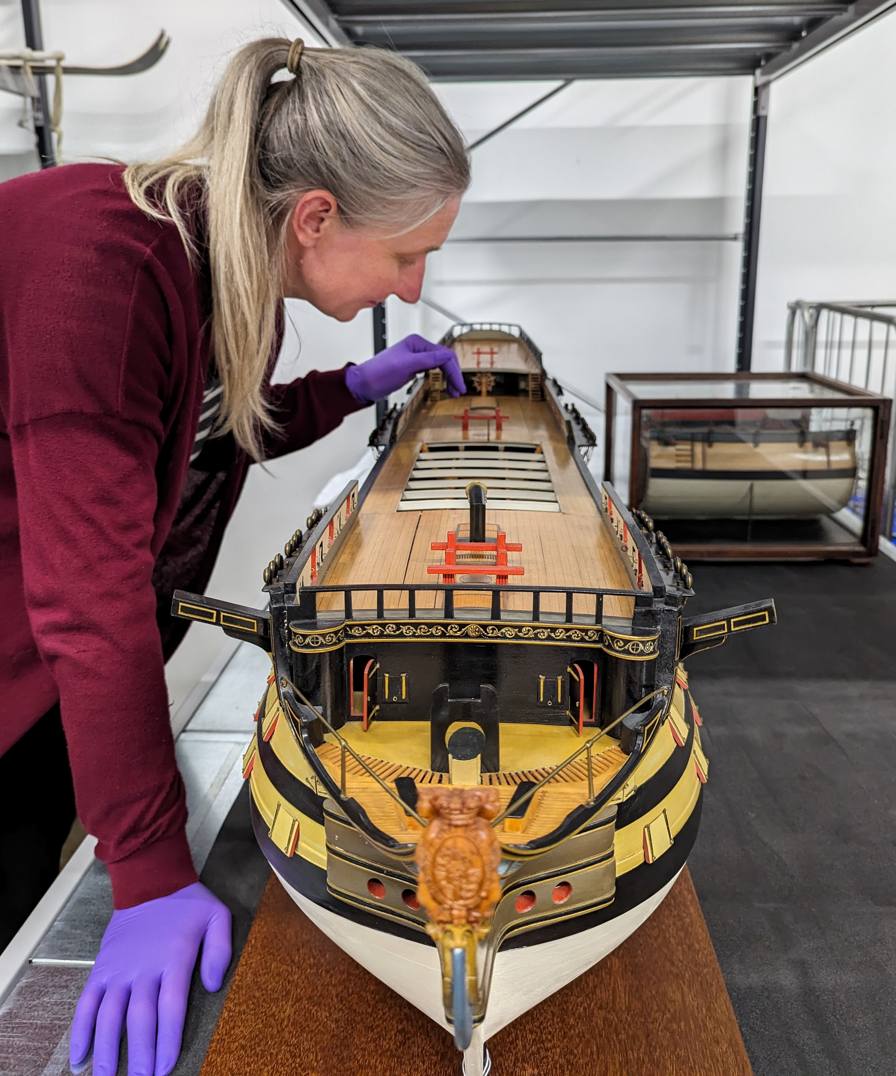 The model of HMS Victory is inspected by Principal Curator Victoria Ingles