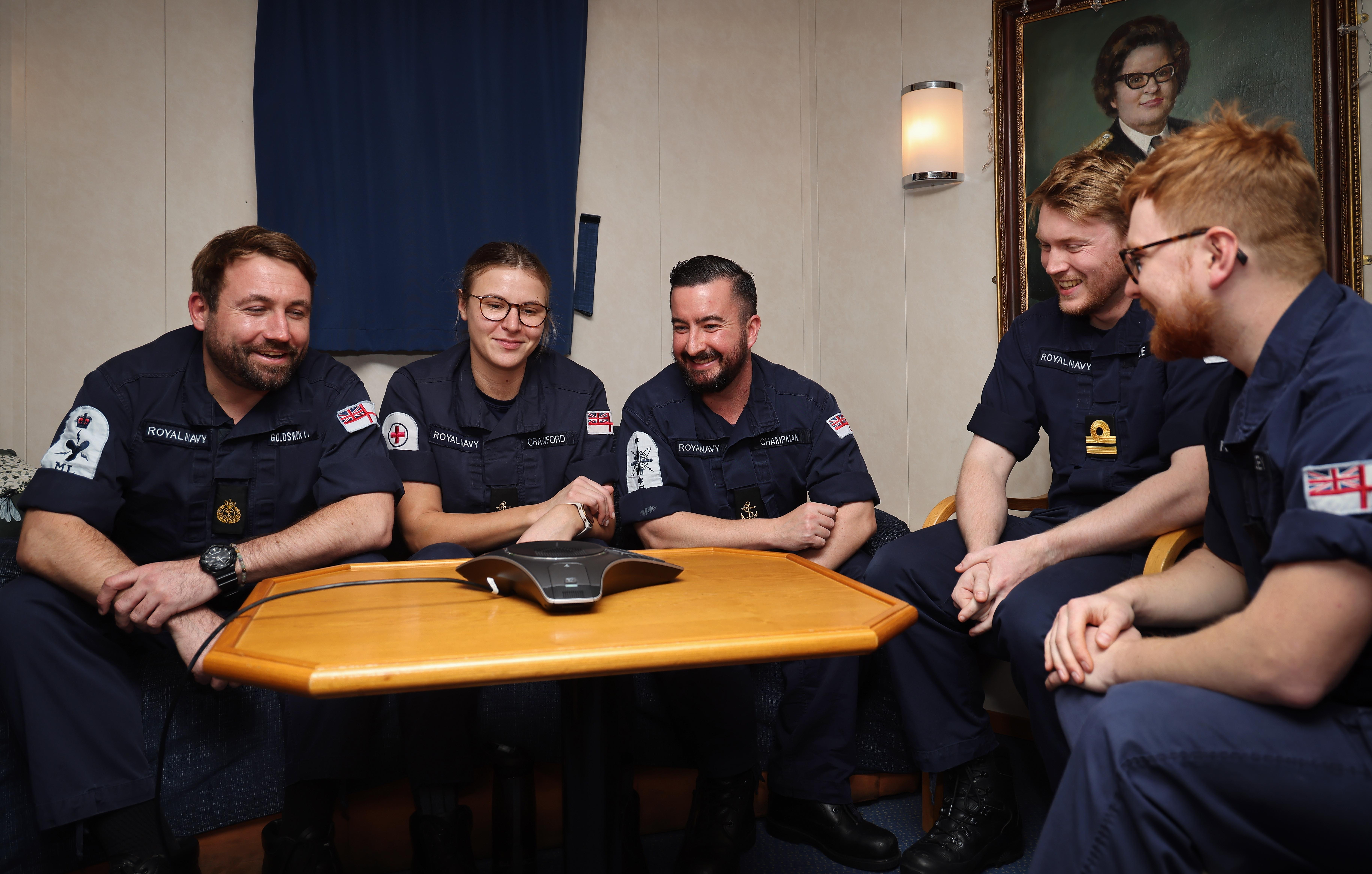 Five of the crew from HMS Protector take a call from the Prime Minister