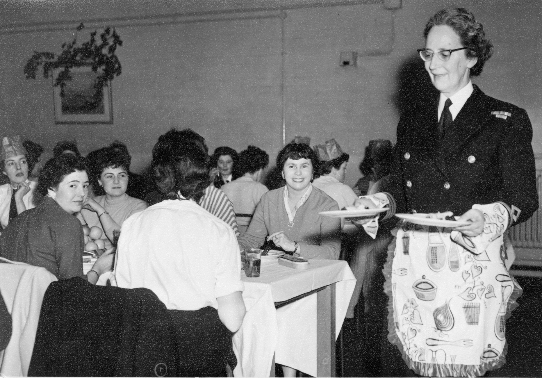 A Superintendent in the Women’s Royal Naval Service serving Christmas Dinner at HMS Dauntless in 1955