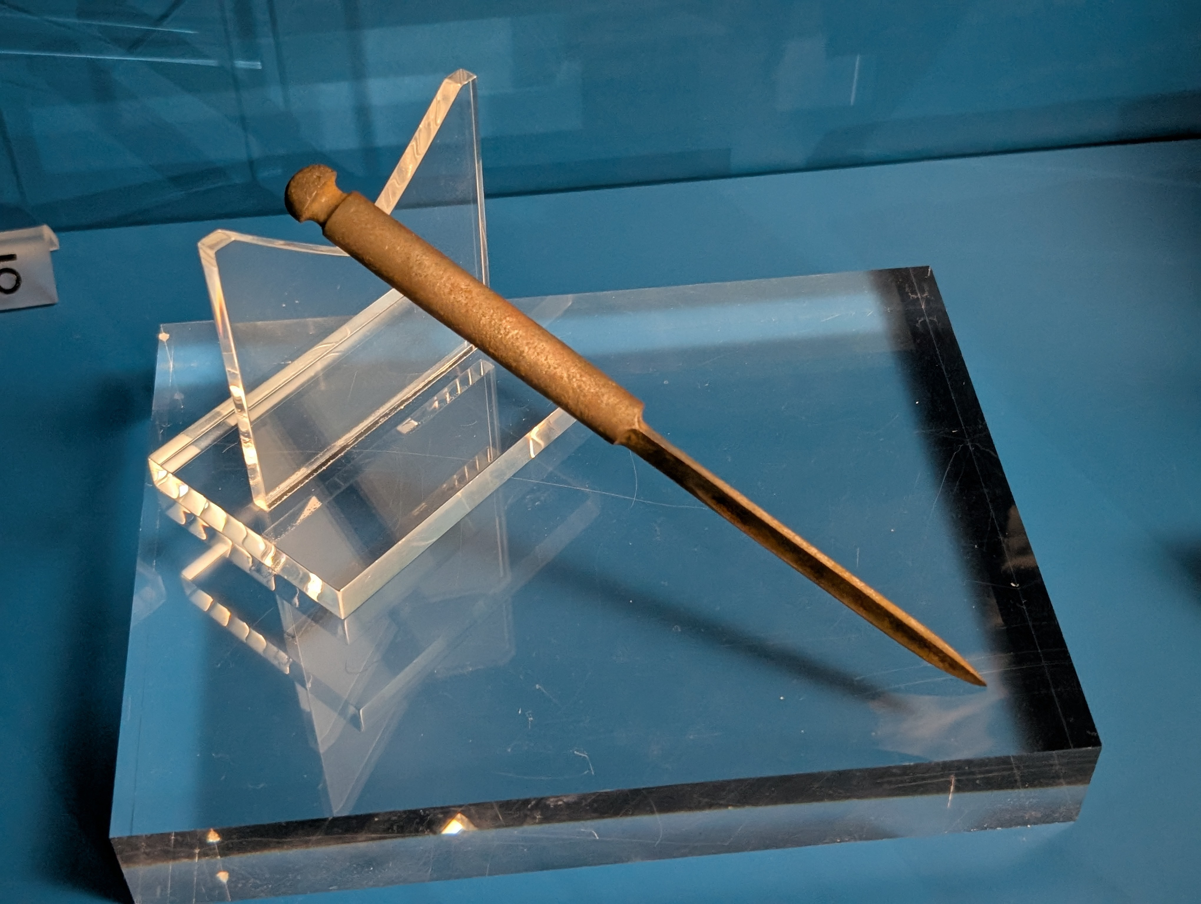 A close-up of a long rusted dagger