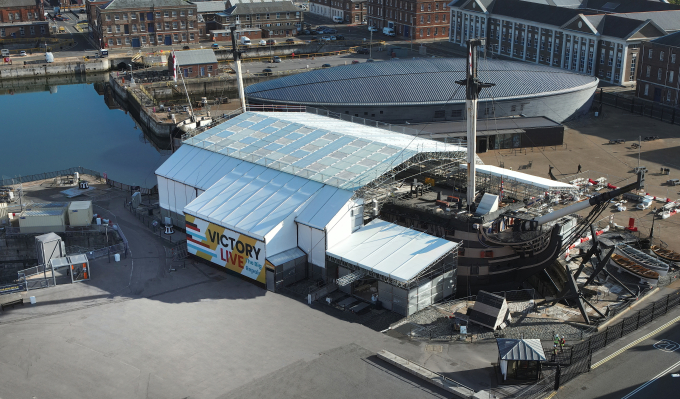 A modern aerial photograph of a Napoleonic-era ship covered in a tent to enable conservation works