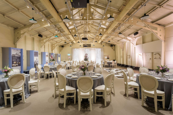 Round table set up on HMS Caroline Drill Hall