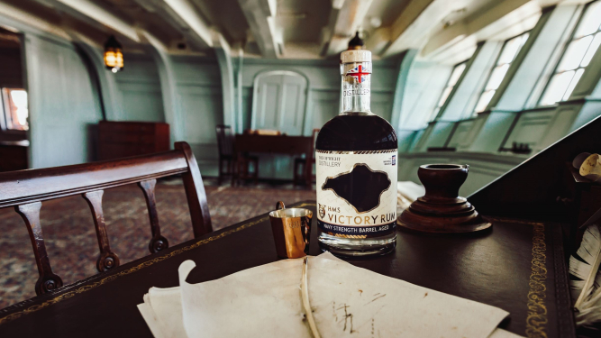 Victory Rum bottle on the desk of Nelson's cabin