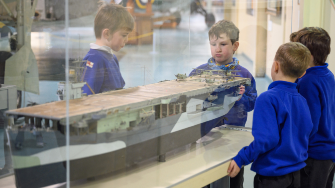 Children looking at carrier model