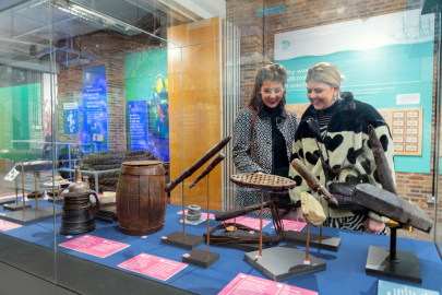 Two women looking at the Diving Deep HMS Invincible 1744 exhibition