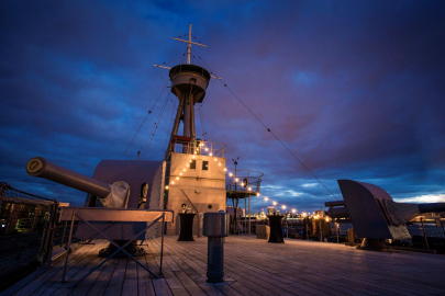 Evening shot with fairy lights on main deck HMS caroline