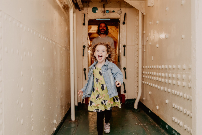 Child runs down corridor aboard HMS Caroline in Belfast