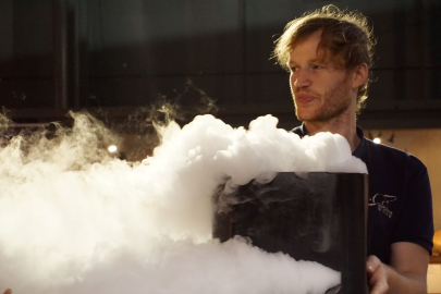 Scientist holding cauldron with smoke