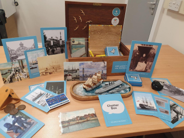 A chatterbox open on a table with its contents on display