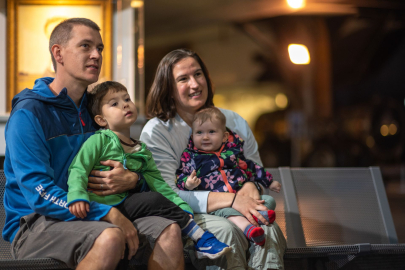 Family with two young children sat watching display