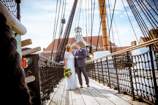 Couple standing on top deck of HMS Trincomalee