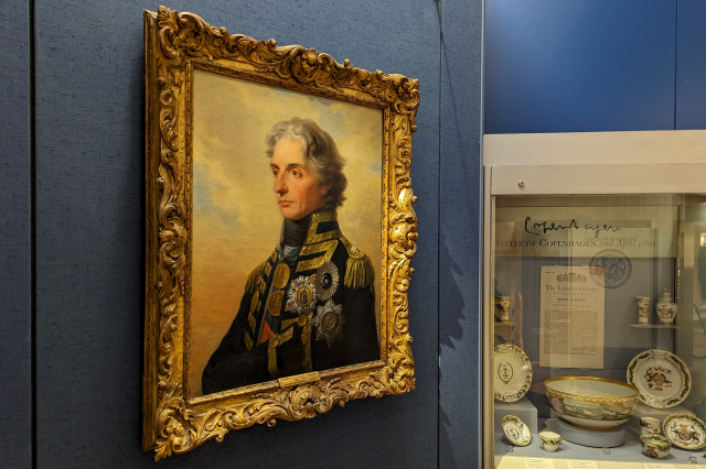 A gallery space featuring a 3/4 angle painting of Vice Admiral Lord Horatio Nelson
