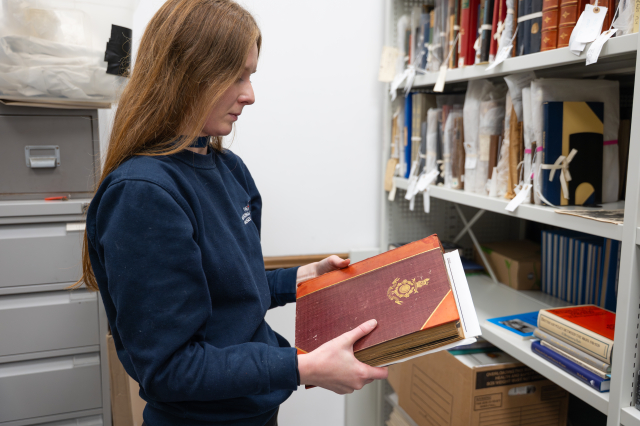 Venue - Curator Holly looking at an object within Storehouse 12
