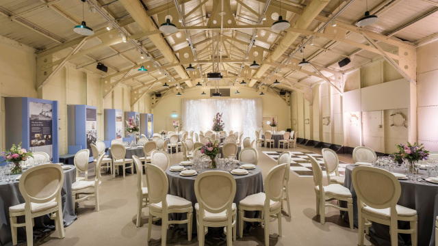 Round table set up on HMS Caroline Drill Hall