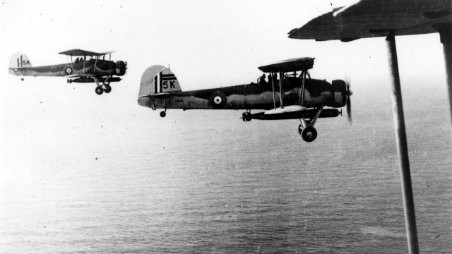 A black and white image of to Swordfish aircraft flying