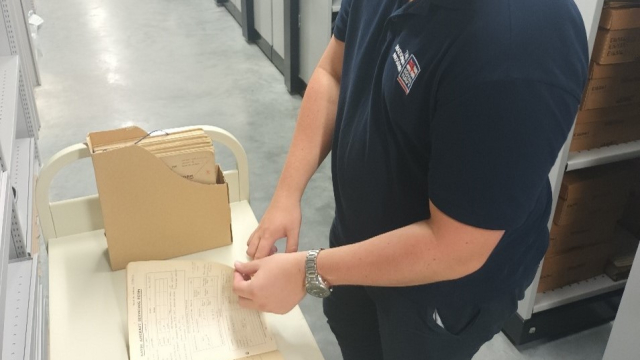 Conservator-looking-at-book