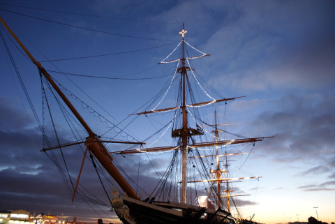 HMS Warrior with a Christmas tree made of lights on her masts