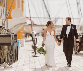 Wedding couple walking along HMS Warrior