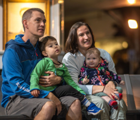 Family with two young children sat watching display
