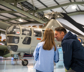 father and daughter looking at helicopter and discussing