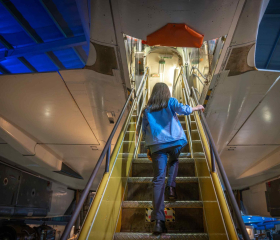 Girl walking up stairs into Concorde 002