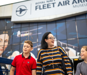family smiling outside of Fleet Air Arm Museum