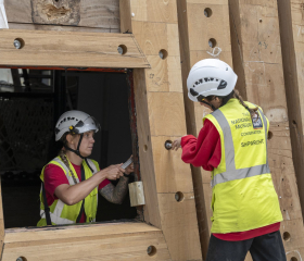 Two shipwrights working on Gunport of HMS Victory Renovation