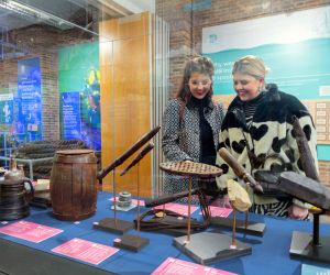 Two women looking at the Diving Deep HMS Invincible 1744 exhibition