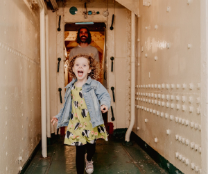 Child runs down corridor aboard HMS Caroline in Belfast