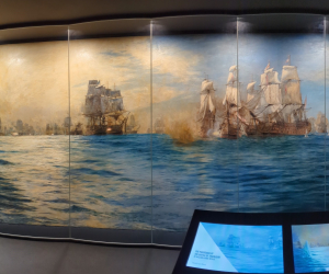 A panoramic photograph of a large naval battle painting