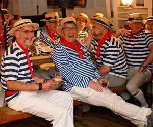 Group of people on table singing