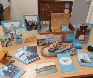 A chatterbox open on a table with its contents on display