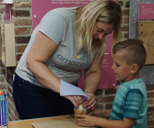 instructor and child working on project together