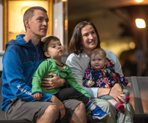 Family with two young children sat watching display