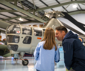 father and daughter looking at helicopter and discussing