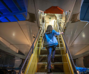Girl walking up stairs into Concorde 002