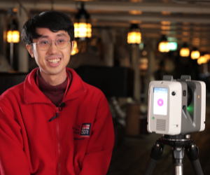 A man sat onboard HMS Victory with a camera for scanning